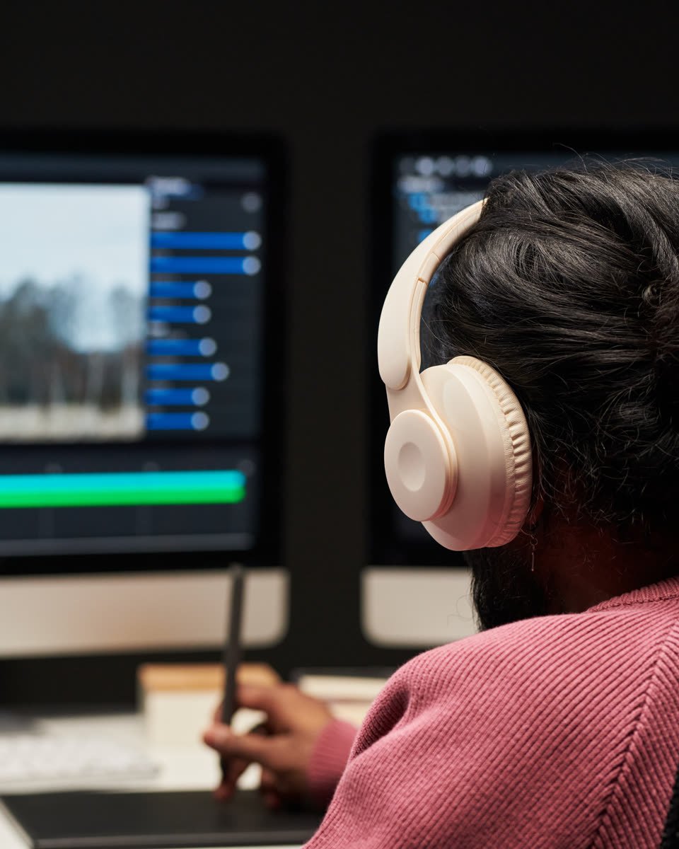 Editor cutting a short-form video on a two-screen timeline